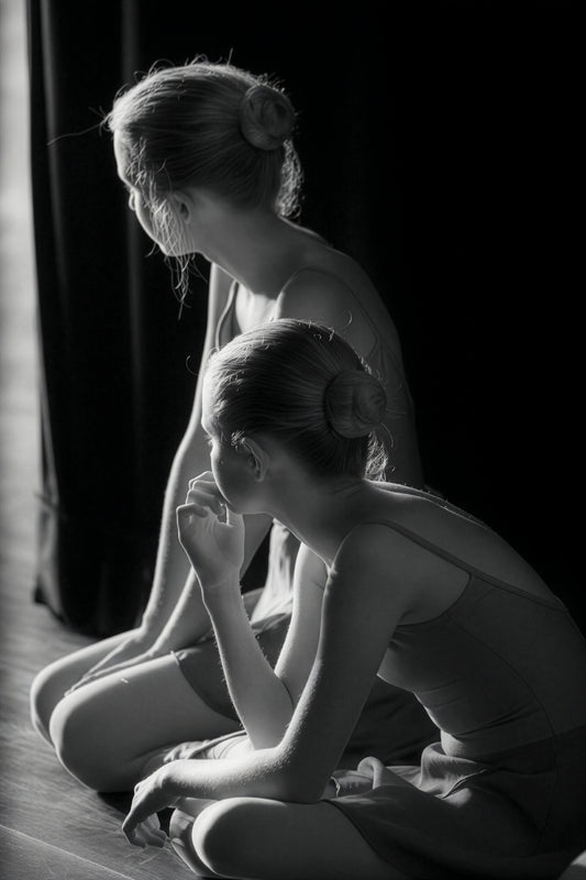 Two young ballet dancers in quiet stillness before a performance