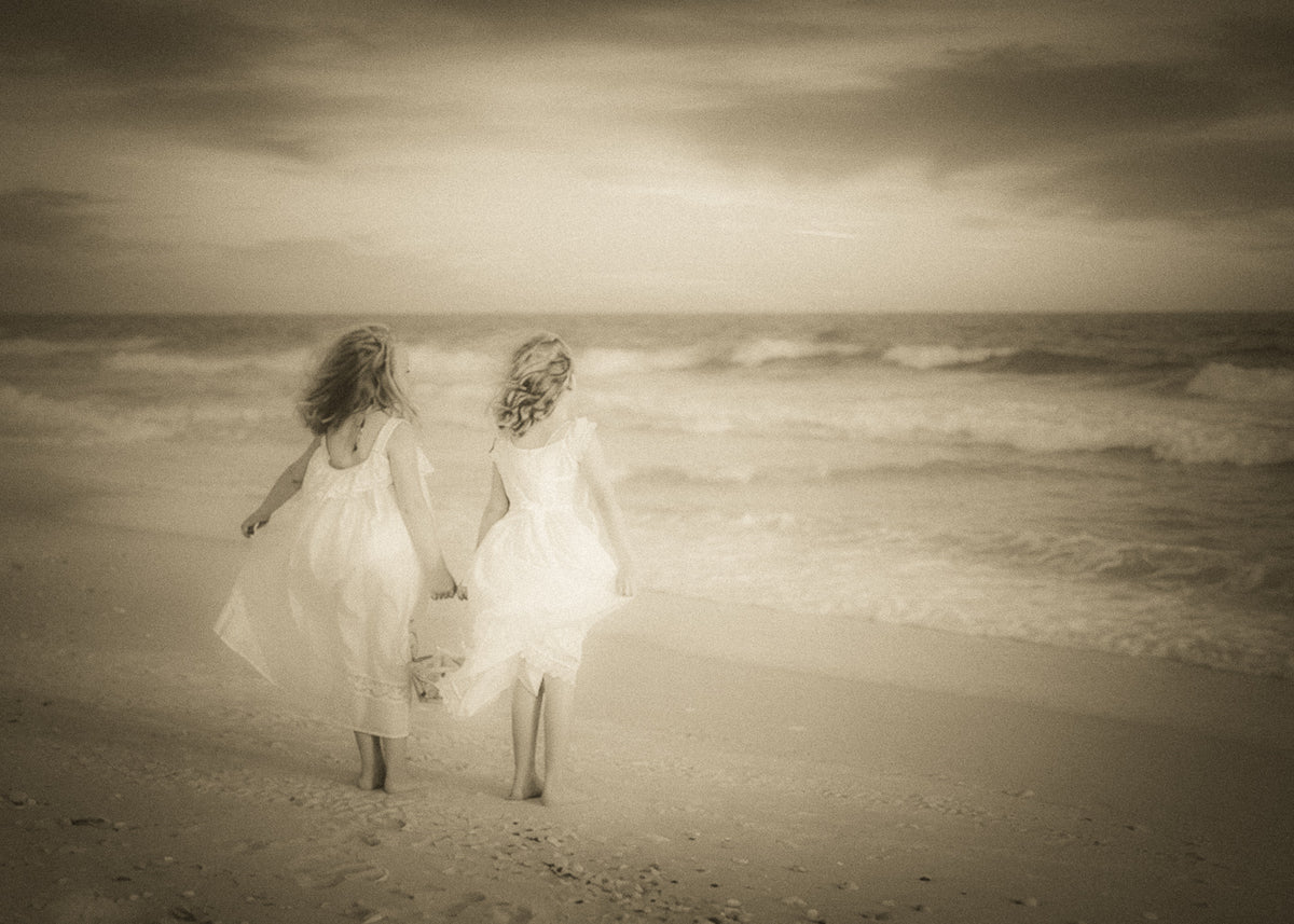 Two friends sharing a quiet moment watching the sunset over the sea