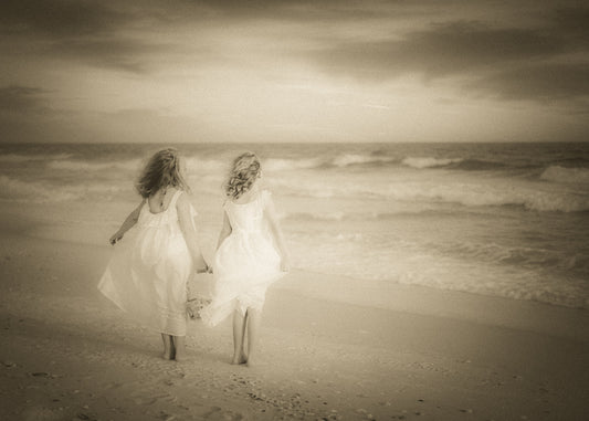 Two friends sharing a quiet moment watching the sunset over the sea