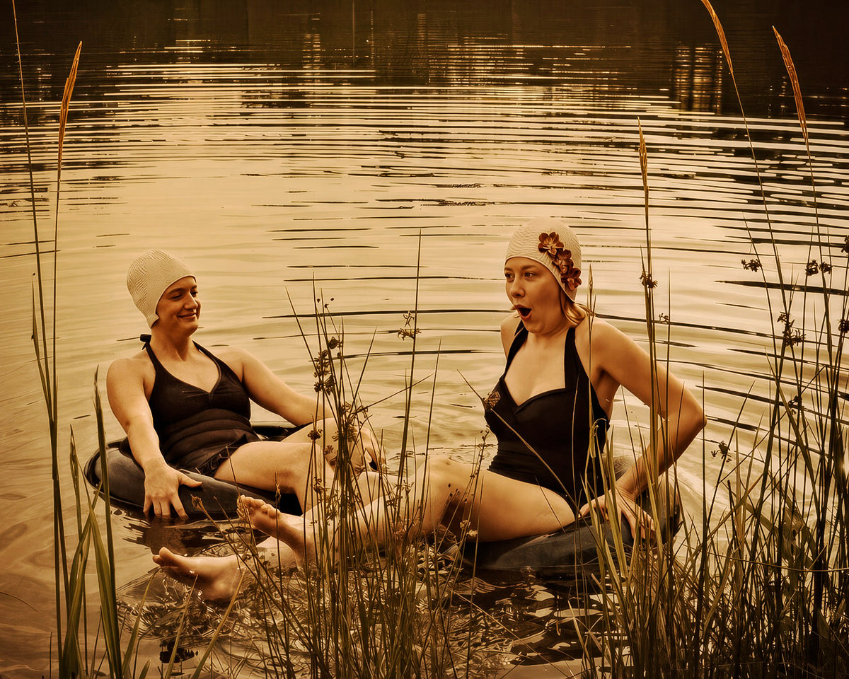 Two women pausing in the warm shallows of a summer lake